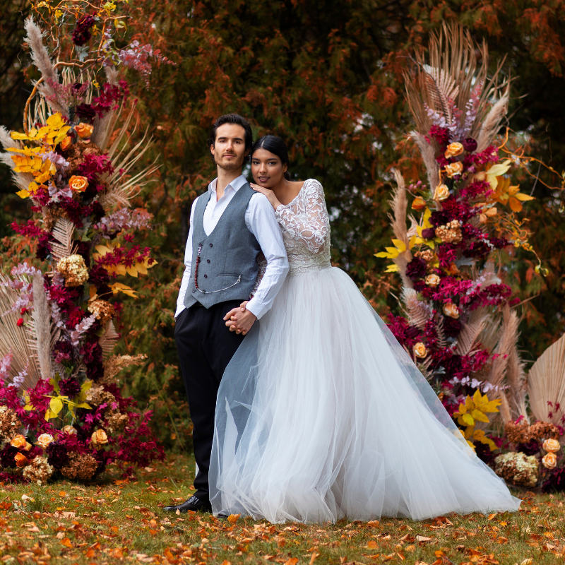 Destination wedding couple with floral arch in Uttarakhand forest